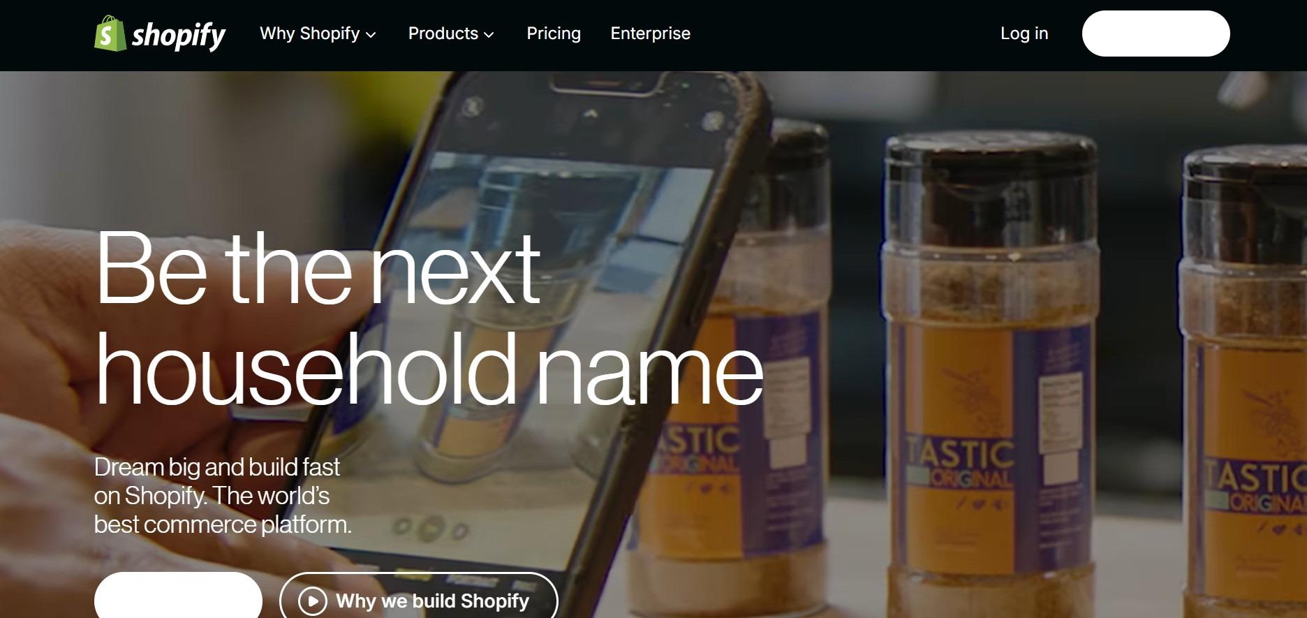 Shopify homepage headline: be the next household name, over a shelf of sauce jars